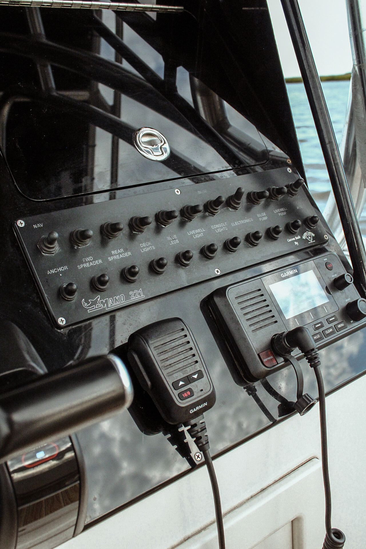 Helm switch panel and Garmin VHF radio aboard the Mako 221