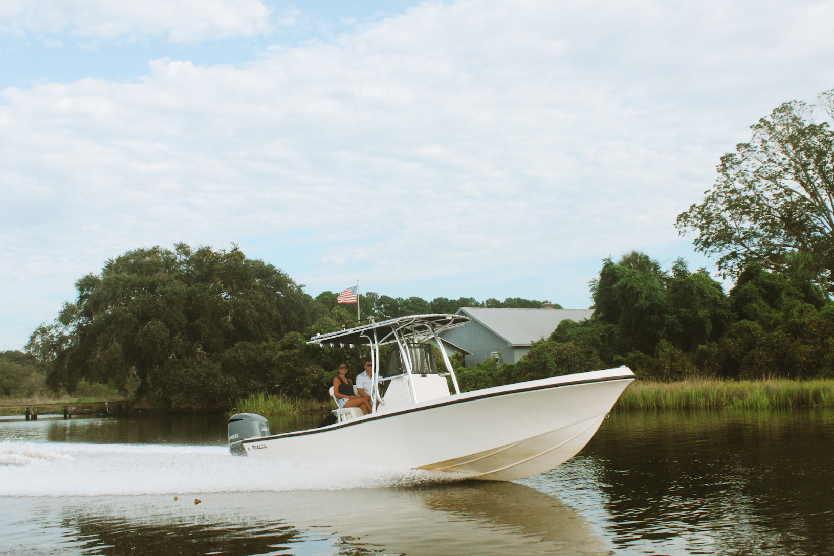 The Money Makin' Mako cruising a tidal creek past the marsh